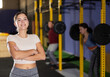 Young girl trainer in sportswear poses in fitness center gym. Active lifestyle, daily workouts in modern crossfit gym