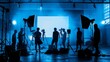 Silhouette of working people or production film crew are making movie or shooting tv on line content live show in studio with camera equipment set.