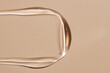 © ADDICTIVE STOCK - Shimmering liquid serum swatch on neutral background