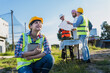 © Jack Tamrong - Young Asian home builder woman using tablet working in construction site with group of engineer and Arab man background
