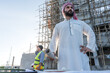 © Jack Tamrong - Arab businessman and developer standing in construction site with worker at work site background