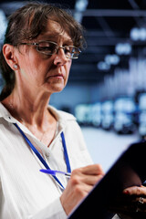 Poster - Experienced employee inside high tech workplace providing computing resources needed for AI to process extensive datasets for training. Server cabinets storing data used for machine learning
