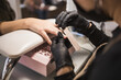 © ADDICTIVE STOCK - Professional manicurist shaping nails at a salon