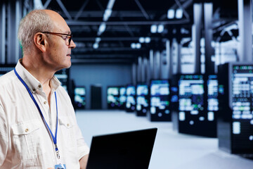 Poster - Qualified specialist using laptop, setting up high bandwidth dedicated multiplayer gaming servers in supercomputer farm to accommodate more traffic from worldwide locations and avoid disruptive lag