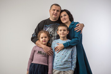 studio portrait of a happy family husband wife daughter and son 3