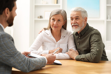 Poster - Notary consulting senior couple about Last Will and Testament in office