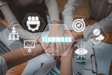 Wall Mural - Teamwork concept, Positive diverse business team putting their hands on top of each other with teamwork icon on virtual screen.