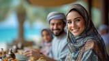 Fototapeta  - islamic family eating together at outdoor restaurant on arabian beach