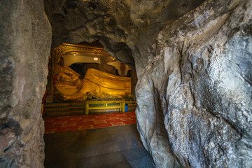 Wall Mural - 
The golden Buddha statues are placed inside a cave at Tham Khao Yoi Temple in Phetchaburi Province. It's a beautiful tourist attraction in Thailand.