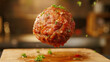 Succulent meatball suspended in mid-air.