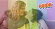 Image of rainbow flag over lesbian couple kissing