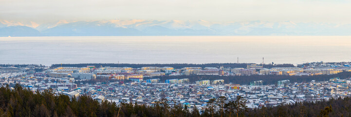 Wall Mural - Severobaikalsk, Republic of Buryatia, Siberia, Russia. View of the city of Severobaikalsk, located on the coast of Lake Baikal. Winter city landscape. Lake Baikal is covered with ice. Wide panorama.