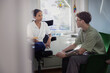 © Johnér - Teenage boy talking with female therapist during psychotherapy session in office