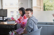 © Johnér - Portrait of smiling gay boy sitting by female friend in clinic