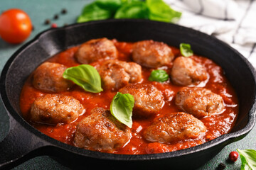 Wall Mural - .Meatballs with tomato sauce and basil in a frying pan