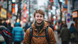 © Jasmina - Young smiling male traveler standing in a crowded Japanese town