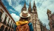 Travel to Spain. Traveler girl looking at Cathedral in old town of Spanish city. Young backpacker tourist in solo travel. Vacation, holiday, trip