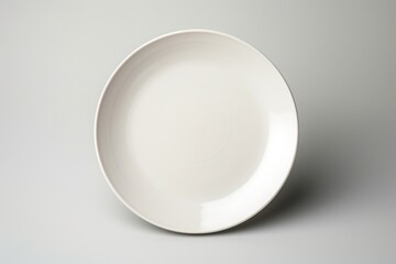 Poster - A simple white plate on a table, versatile for various concepts
