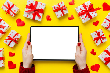 Wall Mural - Female hands using a laptop for Valentine day background, gift box and envelope, hearts