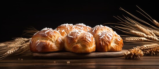 Leinwandbilder - A Variety of Freshly Baked Bread and Wheat Spikelets Arranged on a Rustic Wooden Board