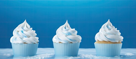 Poster - Delicious Assortment of Three Cupcakes with Whipped Frosting on Top