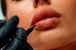 Cosmetologist applying permanent make up on lips of woman in beauty salon