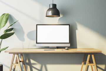 Poster - Modern home office interior with empty white computer monitor on designer desktop. Decorative plant and concrete wall background with shadows. 3D Rendering.