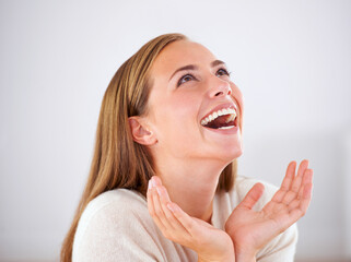 Poster - Laughing, woman and happiness in studio with funny, comedy or reaction to humor in white background. Crazy, joke and girl giggle with joy from thinking of moment in comic or person with a smile