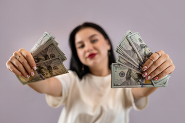 Poster - pretty young woman holding dollar money over pink background