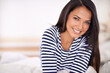 © Arcurs Corp/peopleimages.com - Rest, happy and portrait of woman on sofa in living room with positive, pride or confident attitude. Smile, calm and young female person relaxing on couch in lounge on weekend in modern apartment.