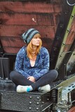 Fototapeta Desenie - Young woman sitting on a train wagon