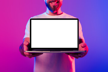 Poster - Cropped of man showing laptop empty screen in neon studio