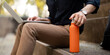 © Natee Meepian - Asian businessman with reusable eco friendly ecological cup using laptop and sitting outside the office building. Eco friendly, sustainable lifestyle concept