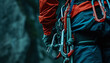 Carabiners, quickdraws, and slings hanging from a climber's harness -wide format