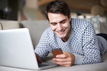 Aufkleber - Man, home and sofa on smartphone with laptop, happy and smile for social media post and entertainment. Male person, living room and couch on internet for streaming service or website for news update