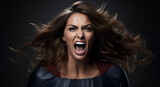 Fototapeta  - Young angry impressive confident woman in a superwoman costume screams furiously on a dark background