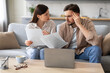 © Prostock-studio - Worried couple reviewing finances with laptop and papers