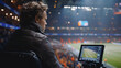 © Vladislav - a broadcaster sitting in a stadium sitting in front of a monitor
