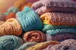 Bright advertising photo, banner. Multi-colored knitted motley clothes lying in a stack. Nice pastel colors, cozy sweaters and scarves.