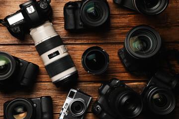 Wall Mural - modern cameras on wooden table, flat lay