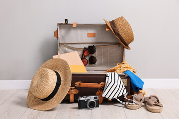 Wall Mural - Clothes, camera and suitcase indoors. Prepare for travel