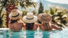 Rear view of three beautiful woman friends in swimsuits relaxing by the pool during their summer holiday. Copy space. Summer and vacation, sunbathing wellness Lifestyle concept.