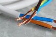 © New Africa - Colorful electrical wires on gray surface, closeup