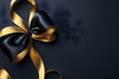 © Pacharee - Luxury golden and black ribbon on dark background.