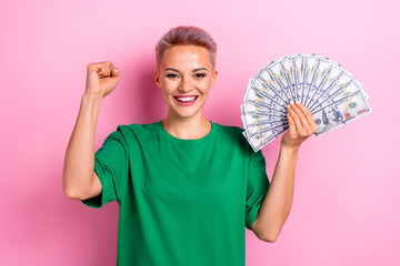 Wall Mural - Photo of cheerful glad positive woman wear green trendy clothes celebrate win million isolated on pink color background