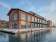 The factory's exterior by the water showcases its industrial history with docks and cranes.