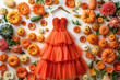 A unique dress crafted from delicate tulle fabric and adorned with vibrant pumpkins, creating a whimsical and enchanting ensemble