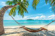 Hammock on the beach with palm trees and turquoise sea