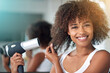 © Mapodile M/peopleimages.com - Black woman, hairdryer and hair with texture in portrait, curly hairstyle or frizz for morning routine in bathroom. Natural beauty, haircare and heat treatment for growth, shine and cosmetics at home