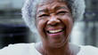 One joyful black elderly woman with gray hair, wrinkles, and happy friendly smile. Charismatic South American senior person of African descent portrait face close-up